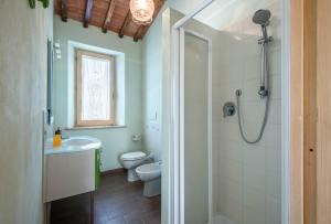 a bathroom with a toilet and a sink and a shower at Appartamento Belvedere in Lano