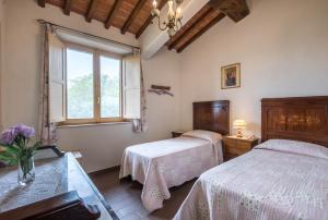 a bedroom with two beds and a window at Appartamento Belvedere in Lano