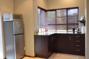 a kitchen with a refrigerator and a window at Jade Mountain Cottage 玉山小屋 in White River