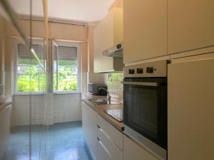 a kitchen with a sink and a stove top oven at Viale Hanbury in Alassio