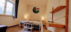 a room with a bed and a table and stairs at Ai Laghi Bed&Bed in Messina