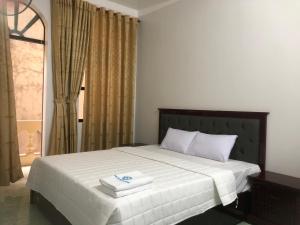 Posteľ alebo postele v izbe v ubytovaní Hotel Nam Sơn Tân Dương