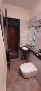 a bathroom with a toilet and a sink at Sia Resort in Nagaon