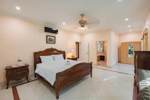 a large bedroom with a bed and a hallway at IvyRich Pool Villa Chiang Mai in Hang Dong