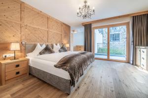 sypialnia z dużym łóżkiem i dużym oknem w obiekcie Gletscherblick- serviced apartments w mieście Obergurgl