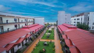 an aerial view of a city with buildings and horses in a courtyard at Sher Bengal Beach Resort in Mandarmoni