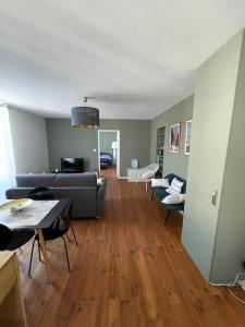a living room with a couch and a table at Le Coeur de Rodez in Rodez