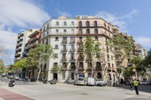 a large white building on the corner of a street at Sagrada Familia 360 in Barcelona