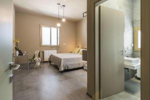 a bedroom with a bed and a sink in a room at Villa Bizzarria in Castellammare del Golfo +32 photos