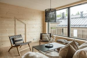 a living room with a couch and chairs and a table at Martebäcken 21 in Sälen