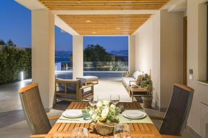 a dining room with a table and chairs and a patio at Villa Bizzarria in Castellammare del Golfo