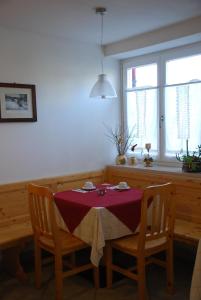 a table and two chairs with a table and a window at Affittacamere Dai Stoneri in Cavareno