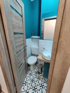 a bathroom with a toilet and a sink at Harmony House in Oradea +22 photos
