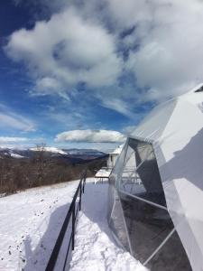 a tent in the snow next to a fence at Dilijan Glamping in Dilijan