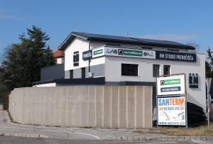 a white house with a sign in front of it at RM Roma Studio in Celje