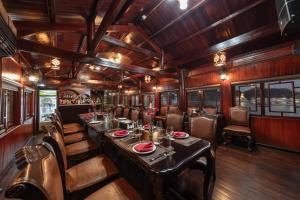 a train dining room with a long table and chairs at Ruby Cruise in Ha Long