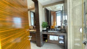 a bathroom with two sinks and a large mirror at Guangzhou Xing Yi International Apartment - Poly World Branch in Guangzhou