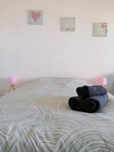 a teddy bear laying on top of a bed at Studio Lovely Sea in Le Barcarès