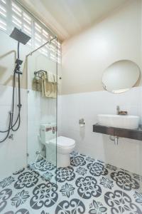 a bathroom with a shower and a toilet and a sink at KW by Trava All Inclusive Boutique Hotel in Chiang Mai