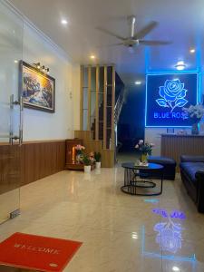 a lobby with a bluerosis sign on the wall at Blue Rose Hotel in Ha Long
