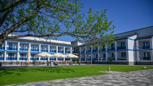 a large white building with blue accents at NN Boutique Hotel**** in Tiszaújváros