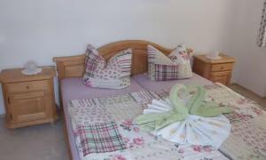 a bedroom with a bed with pillows and a bedspread with flowers at Ferienwohnung Grüsser-kagerhuber in Schönau am Königssee