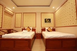 two twin beds in a room at THANH TAI HOTEl 1 in Ho Chi Minh City