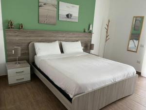 a bedroom with a large bed with a wooden headboard at Vista Stromboli in Paola