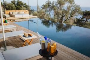 a view of a swimming pool from the deck of a house at Five Olive Dream Trip - Luxury Suites with Sea View in Plomari