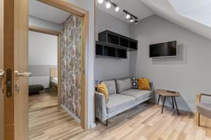 a living room with a couch and a table at Stay Express in Vilnius