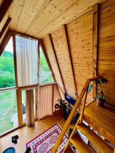 a room with a staircase in a log cabin at Cottage Sataplia in Kutaisi