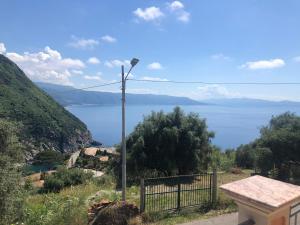 a street light on a hill with a view of the water at Residence La Marinella in Palmi