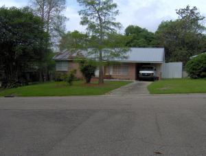 a house with a truck parked in front of it at Mid-Century Modern meets Cajun Creole in Baton Rouge