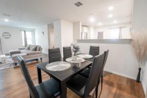 a dining room and living room with a table and chairs at Charming Home near Seaworld in Helotes