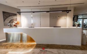 a lobby with a white counter and a counter top at Best Western Premier Ark Hotel in Tirana