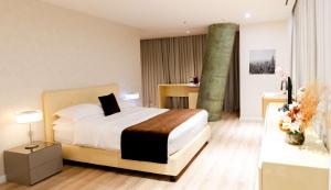 a hotel room with a bed and a bathroom at Best Western Premier Ark Hotel in Tirana