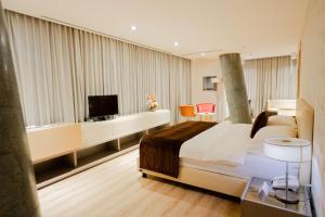 a hotel room with a large bed and a television at Best Western Premier Ark Hotel in Tirana
