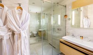 a bathroom with a shower and a sink at Best Western Premier Ark Hotel in Tirana