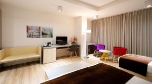 a hotel room with a bed and a desk at Best Western Premier Ark Hotel in Tirana