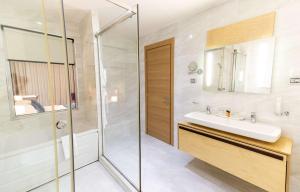 a bathroom with a sink and a shower at Best Western Premier Ark Hotel in Tirana