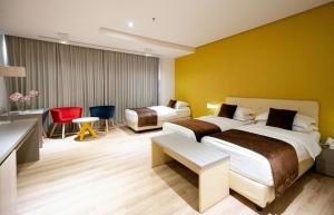 a hotel room with two beds and a table and chairs at Best Western Premier Ark Hotel in Tirana