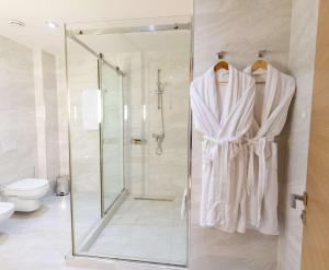 a bathroom with a shower and a toilet at Best Western Premier Ark Hotel in Tirana