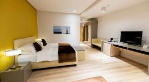 a bedroom with a bed and a flat screen tv at Best Western Premier Ark Hotel in Tirana
