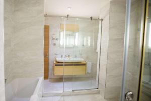a bathroom with a tub and a sink and a shower at Best Western Premier Ark Hotel in Tirana