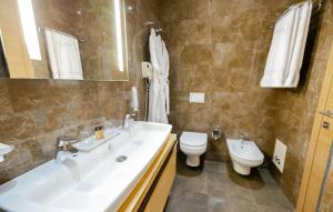 a bathroom with a sink and a toilet at Best Western Premier Ark Hotel in Tirana