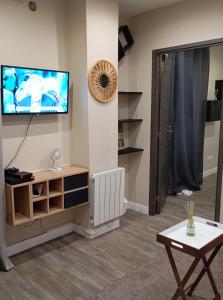 a living room with a flat screen tv on a wall at Appartement 2 pièces a louer in Saint-Denis