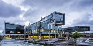 a large glass building with a lot of windows at Pure Luxury Modern Apt Heart of CBD Car Park in Adelaide