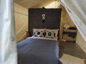 a bedroom with a bed in a tent at Glamping Casa Soarelui in Vama Veche +6 photos