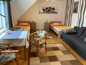 a attic room with two beds and a couch at Gasthaus Kienbaum in Kienbaum