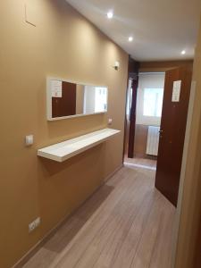 a bathroom with a sink and a mirror on the wall at Apartamento Enol in Cangas de Onís